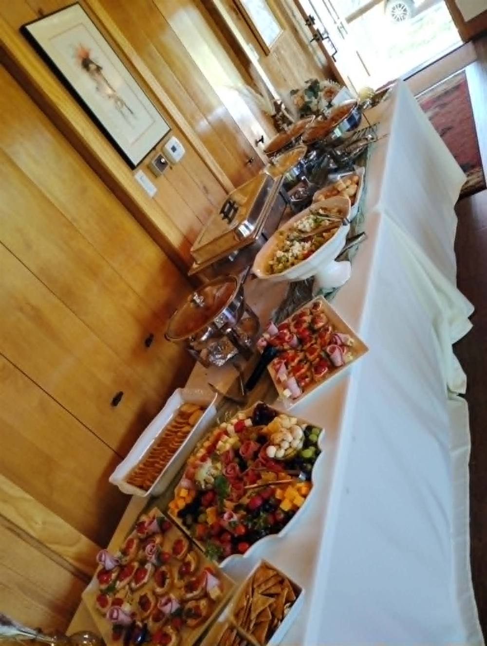 Buffet table set up with catered food for guests to serve themselves
