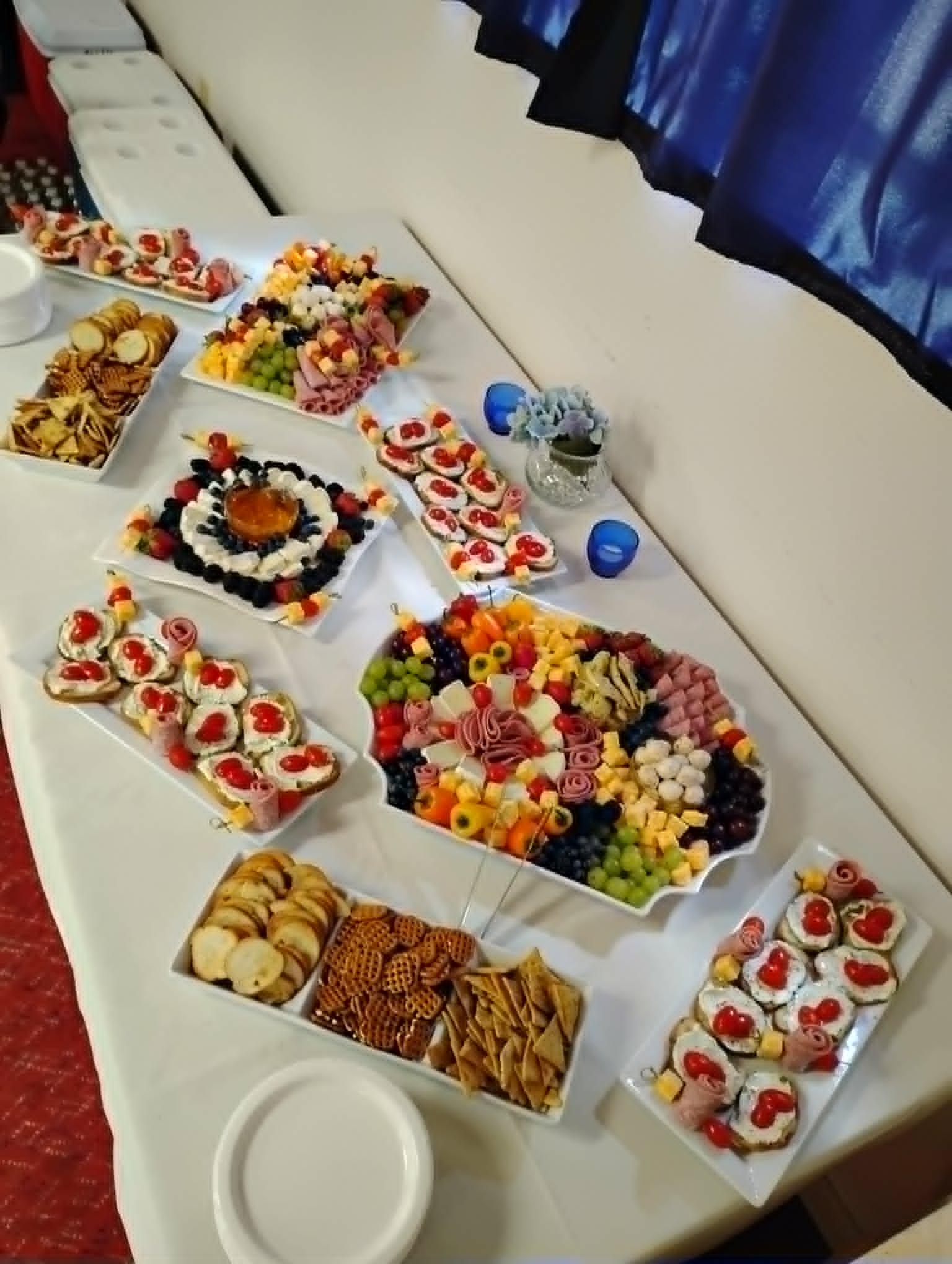 Elegant catering spread with charcuterie, crostini, and desserts arranged for an event
